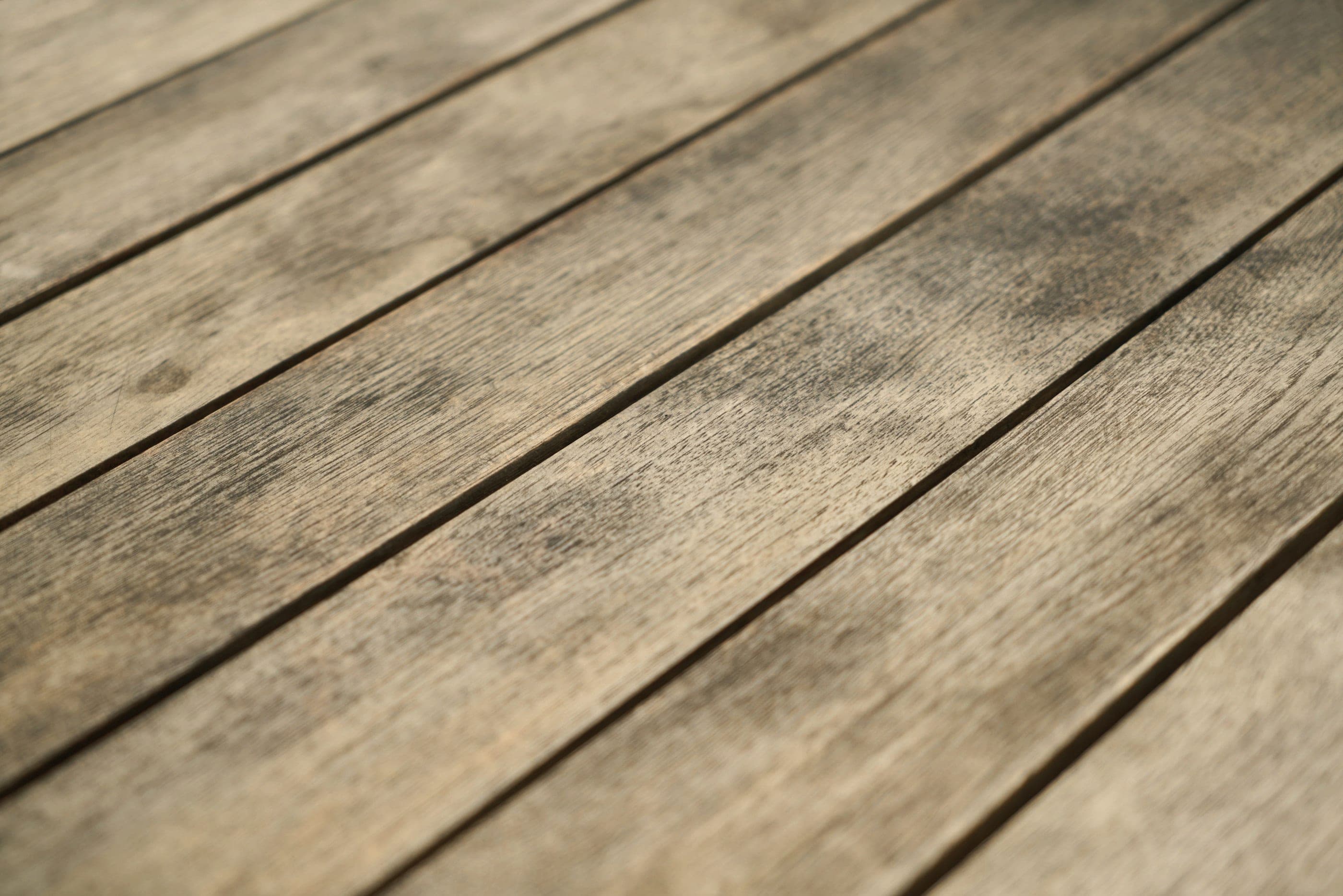 Weathered hardwood decking, close up.